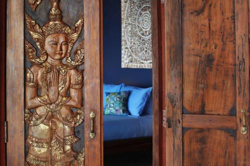 una puerta de madera con una estatua de Buda en Stunning seaview, Gorgeous Villa of architect 4br, en Ko Pha Ngan