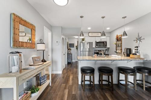 a kitchen and living room with a counter and stools at Free Silver Dollar City Tickets & other attractions! Branson, Walk-In Available in Reeds Spring