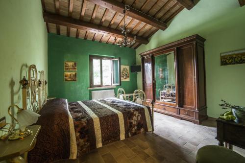 een slaapkamer met groene muren en een bed in een kamer bij Agriturismo Corte Decia in Saludecio