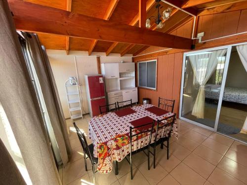 a kitchen with a table and chairs in a room at Casa Amoblada en Coronel 2 in Coronel