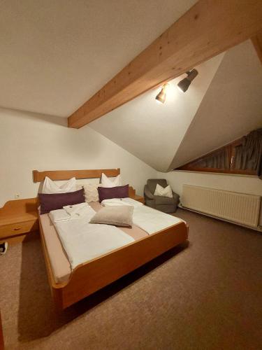 a bedroom with a large bed in a attic at Ferienwohnung Vesna & Alex in Elmen