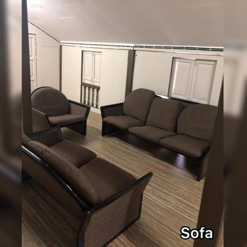 a living room with a couch and two chairs at Serambi Homestay Kangar in Kangar