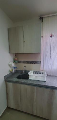 a kitchen counter with a sink and a window at Come to Paradise an be our Guest in Dream Cancun!! in Cancún