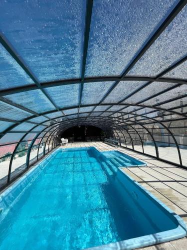 a swimming pool in a tunnel with blue water at BOHO HOUSE in Ustrzyki Dolne
