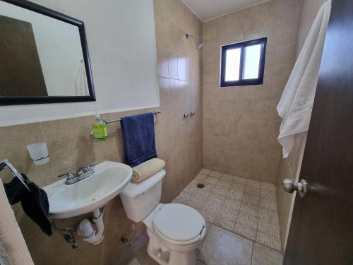 a bathroom with a toilet and a sink at Casa muy Ubicada Amplia con alberca Montejo SD in Querétaro