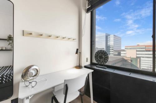 a room with a desk and a large window at Epic Furnished Private Room With Shared Bath in Philadelphia