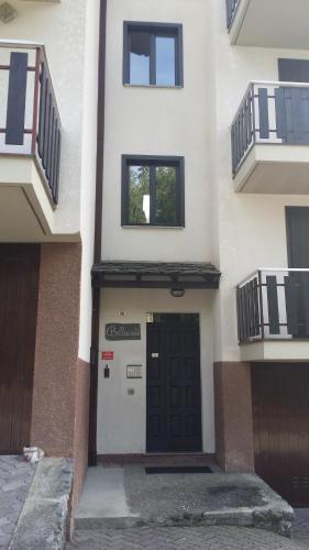 a front door of a building with a garage at Santa Elisabetta Apartment in Caspoggio