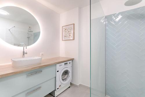 a bathroom with a sink and a washing machine at Résidor - Beautiful appartment 2P in Paris