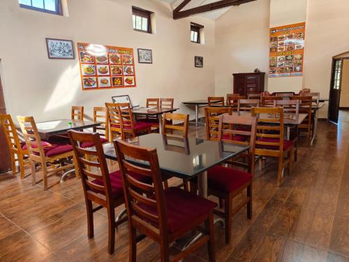 a dining room filled with tables and chairs at Heritage Inn by Brown Tree Resorts in Ooty