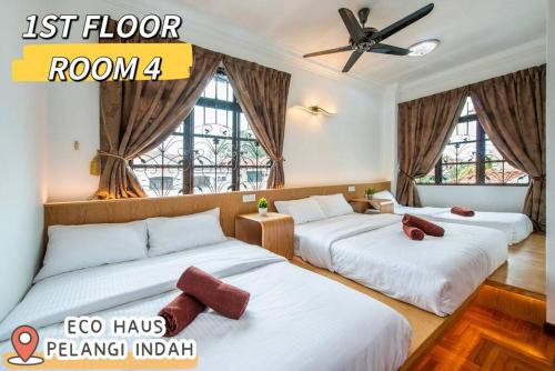 a hotel room with two beds and a ceiling fan at ECOHAUs AeonTebrau/Pool/Netflix/Karaoke/Gaming in Ulu Tiram
