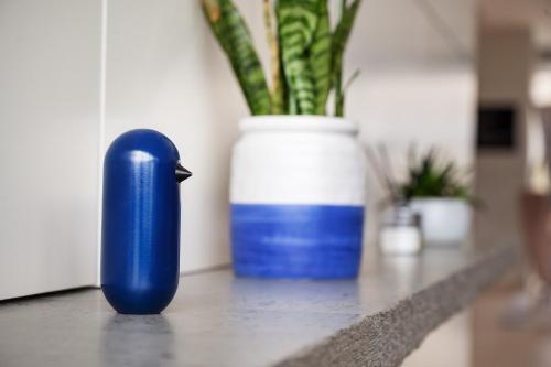 a blue bottle sitting on a counter next to a vase at voco Vienna Prater, an IHG Hotel in Vienna