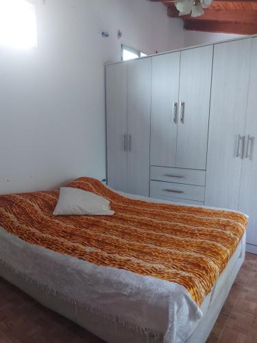 a bedroom with a large bed with white cabinets at Casa en Pueblo Esther in Esther