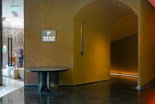 a table in a room with a sign on a wall at Paco Hotel Yan Jiang Road Tuan Yi Da Metro Guangzhou-Free shuttle bus to Canton Fair in Guangzhou