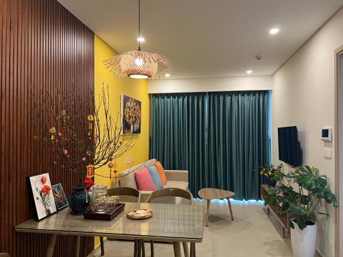 a living room with a table and a couch at The Sóng Vũng Tàu - Mochi House in Vung Tau