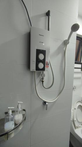 a bathroom with a soap dispenser on a wall at Horizon Delux Suite @ Ipoh Town in Ipoh