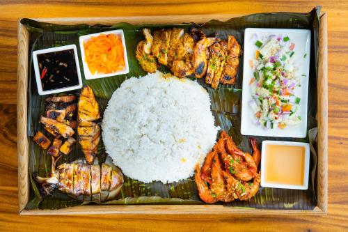 a tray of food with rice and other food items at Best Western Plus The Ivywall Resort-Panglao in Panglao
