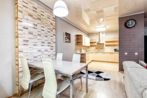 a kitchen and dining room with a table and chairs at Замок столицы in Astana