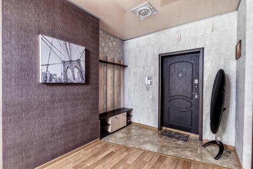 a hallway with a black door and a picture on a wall at Замок столицы in Astana