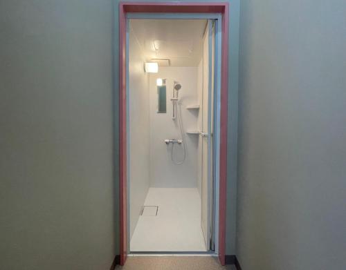 a walk in shower in a bathroom with a mirror at LivingAnywhere Commonsうるま Female Dormitory bunk bed - Vacation STAY 15503v in Uruma