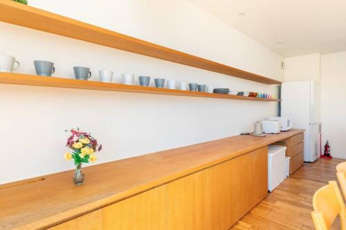 a kitchen with a counter with a vase of flowers at One house Naganuma MAOI in Naganuma