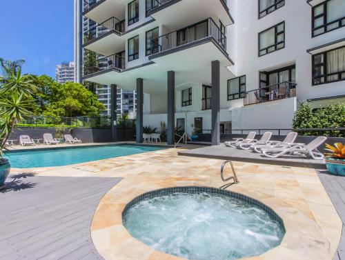 a hot tub in the courtyard of a building at Neptune Resort in Gold Coast