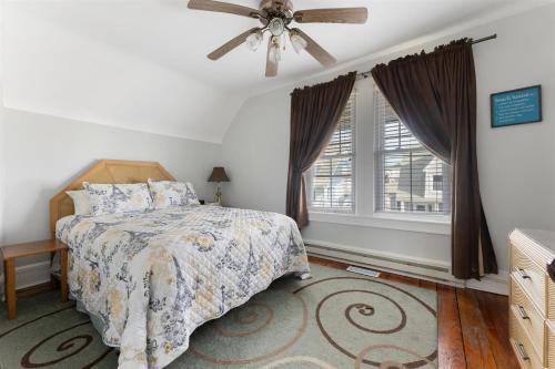 a bedroom with a bed and a ceiling fan at 232 W Pine Ave 4 Beds, 2 Baths in Wildwood