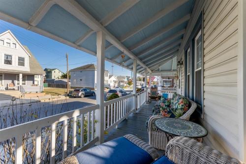 a porch with chairs and tables on a house at 232 W Pine Ave 4 Beds, 2 Baths in Wildwood