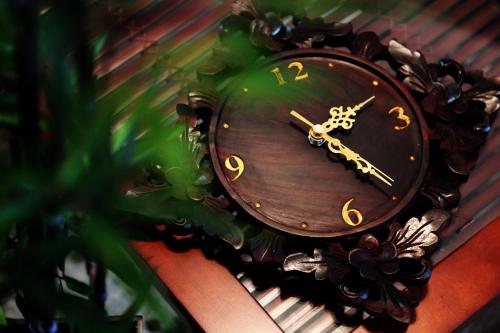 a brown clock with gold numbers on a wall at 高原マンション 201 in Matsuyama