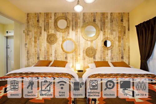 a bedroom with two beds and a wall with mirrors at AirHOME TOKYO EBISU 102 in Tokyo