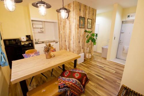 a kitchen and dining room with a wooden table at AirHOME TOKYO EBISU 102 in Tokyo