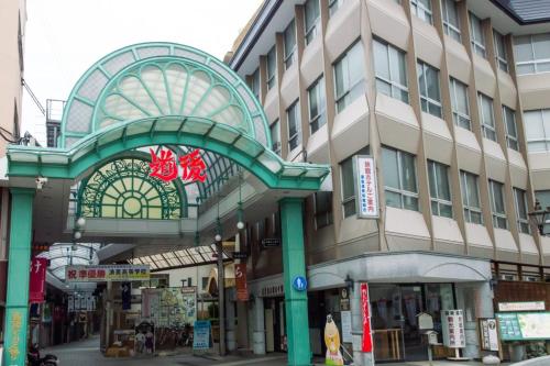 a building with an archway in front of a street at 高原マンション 202 in Matsuyama