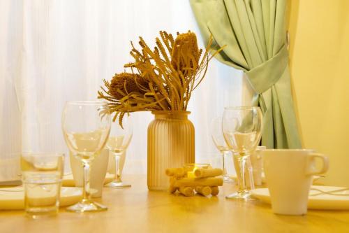 a table with wine glasses and a vase with flowers at AirHOME TOKYO EBISU 102 in Tokyo
