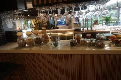 a kitchen counter with jars of food on it at Holiday Inn Clermont Ferrand Centre by IHG in Clermont-Ferrand