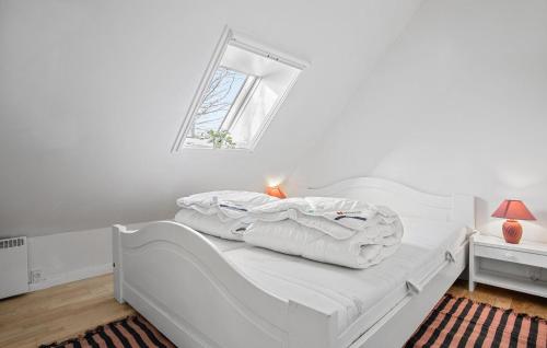 a white bed in a white room with a window at Beautiful Apartment In Dalmose With Wi-fi 
