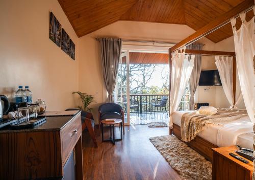 a bedroom with a bed and a kitchen with a balcony at Moustache Bhimtal Luxuria, Nainital in Bhīm Tāl