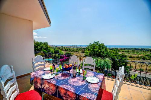 a dining table and chairs on a balcony at Can Ferran by Hello Homes Sitges in Sitges