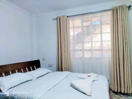 En eller flere senge i et værelse på Pavleena Residence 2 Bedrooms unit