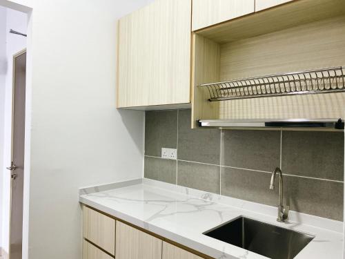 a kitchen with a sink and a counter top at Family 2 Rooms w/t Internet Nilai Youth City A07 in Nilai