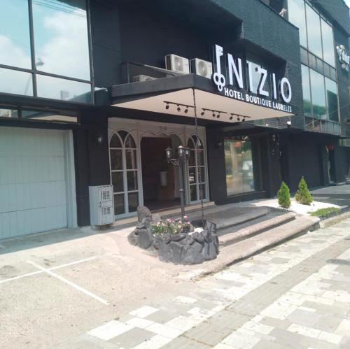 a building with a sign on the front of it at Inizio Hotel Boutique Laureles in Medellín