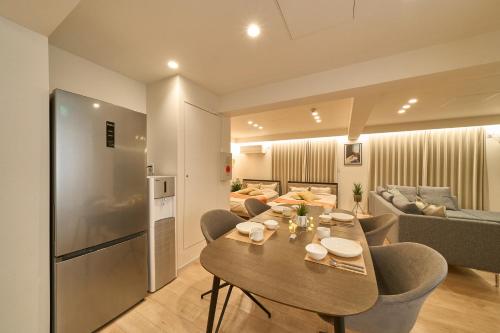 a kitchen and living room with a table and a couch at BETTEI in Oita