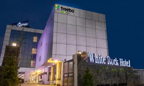 a hotel with a sign on the side of a building at Treebo Trend White Rock - Sohna Road in Gurgaon