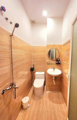 a bathroom with a toilet and a sink at Ohayou Dalat Homestay in Da Lat