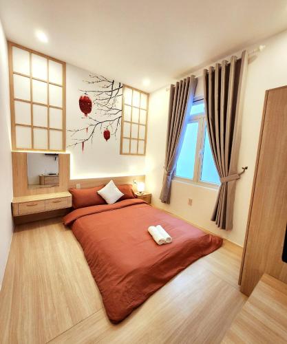 a bedroom with a large bed and a window at Ohayou Dalat Homestay in Da Lat