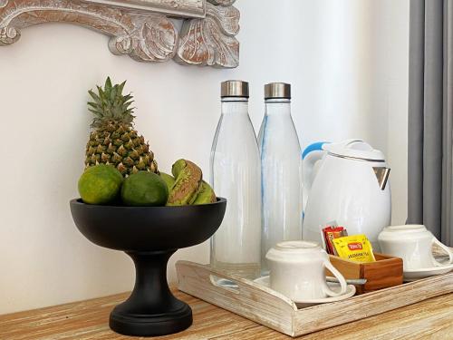 a bowl of fruit and bottles on a table at Mere Sea View Penida in Nusa Penida