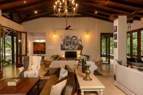 a living room with a couch and a table at The Weir House in Ulapane