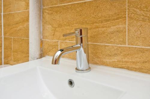 a bathroom sink with a chrome bathroom faucet at 102-1A Best Value 2BR Apt Near Central Park in New York