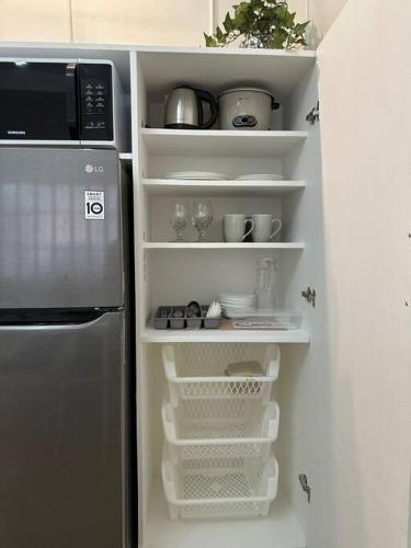 a refrigerator with empty shelves in a kitchen at Japandi Home B - Fully Aircon, WIFI, Hot shower, 24hGuard, Center, near Malls in General Santos