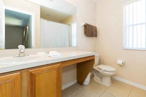 a bathroom with a sink and a toilet at Paradise Palms By Mid Florida Home Management in Orlando