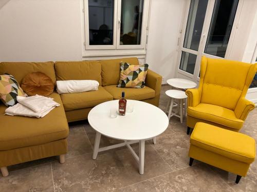 a living room with a couch and two chairs and a table at Entspannen, private Maisonette Dachwohnung in Dielsdorf