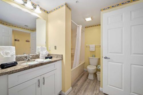 a bathroom with a sink and a toilet at Luxury 10th Floor 1 BR Condo Direct Oceanfront Wyndham Ocean Walk Resort Daytona Beach | 1006 in Daytona Beach